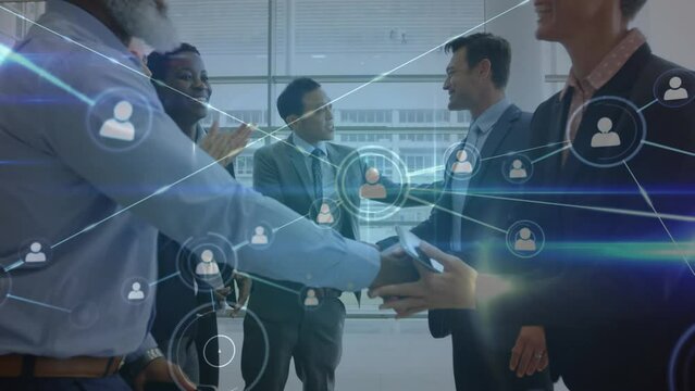 Animation of network of profiles and light trails over diverse bsinesspeople shaking hands at office