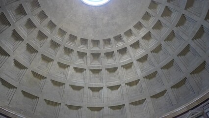 Tilt up shot Oculus at Top of Dome of Pantheon, one of Best-Preserved of all Ancient Roman Buildings. Roof this concrete coffered dome poured into moulds building popular tourist attraction in Rome. - Powered by Adobe