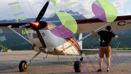 Animation of infographic interface over caucasian man checking glider airplane - Powered by Adobe