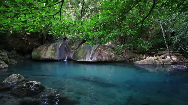 Erawan waterfall beautiful emerald lake and rocks in wild jungle forest in Erawan National park, Kanchanaburi, Thailand