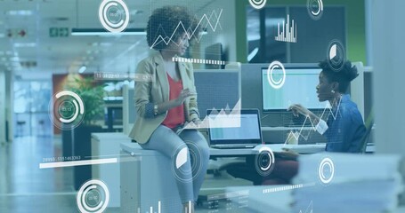 Animation of statistical data processing against two african american women discussing at office - Powered by Adobe