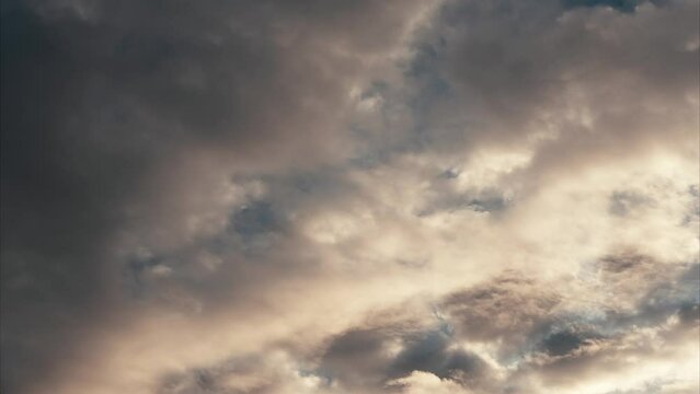 Time lapse of storm clouds rolling in with morning light 
