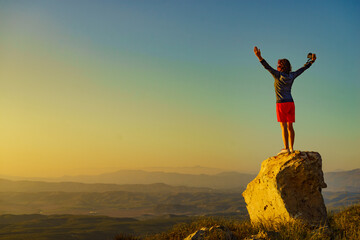 Woman enjoy landscape with arms up