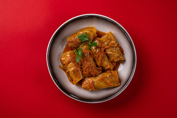 Cabbage Rolls, Stuffed with Meat. On a Red Background, in a Gray Plate.