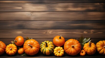 row of pumpkins on a wooden background