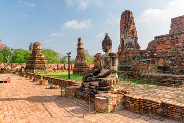 Buddha statue among ruins of the Wat Mahathat in Ayutthaya