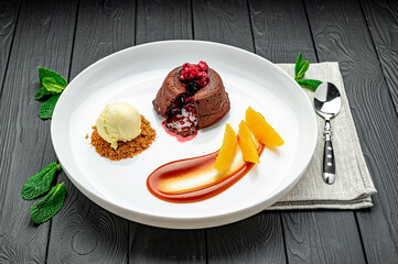 Tasty fondant with ice cream poured with caramel