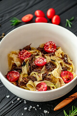 Tagliatelle with stewed veal with truffle paste, cheri and parmesan. Pasta with veal