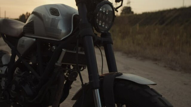 A close-up on a motorcycle in a background sunlight