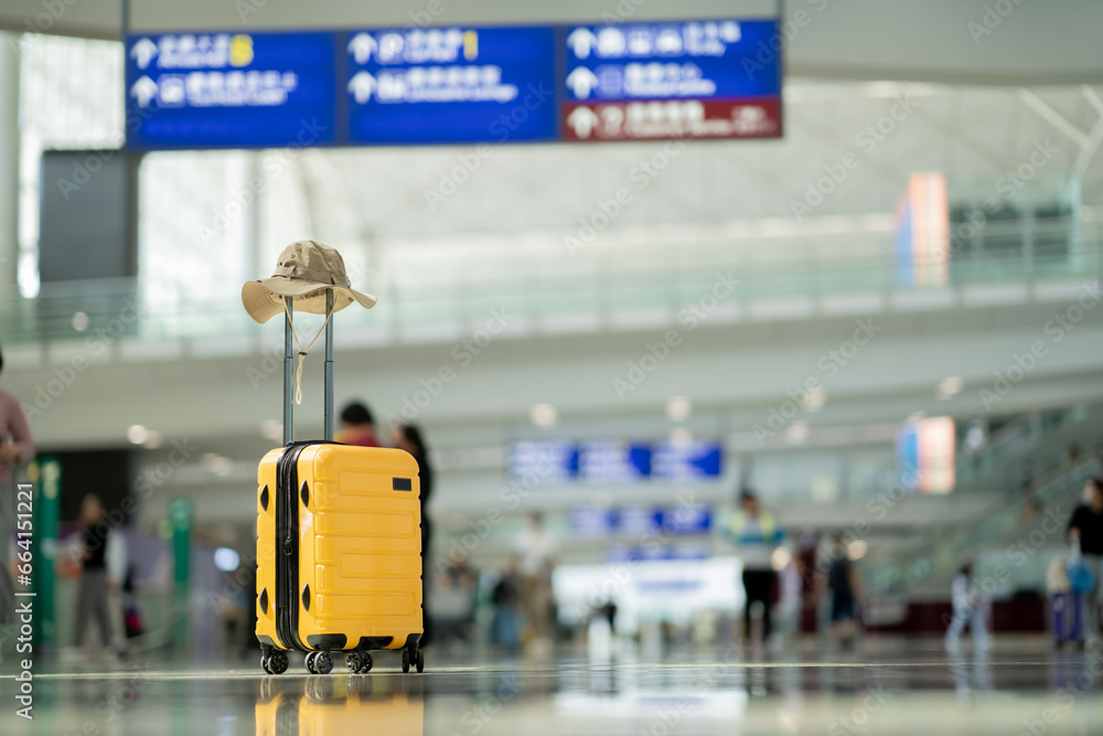 Wall mural the suitcases in an empty airport hall, traveler cases in the departure airport terminal waiting for