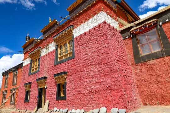 Experience the serene maroon fa&ccedil;ade of Tangyud Monastery in Komic, the world's highest motorable village, set against the stunning Spiti Valley backdrop in Himachal Pradesh, India