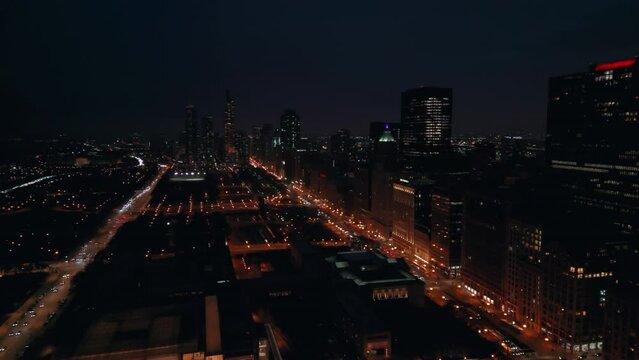 Night street in Downtown Chicago skyscraper in the evening time. Aerial wide footage Chicago IL. USA 29 december 2022