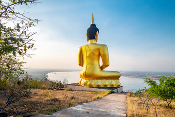 Large Golden Buddha statue at Wat Phousalao,overlooking Mekong River at sunset,Pakse,Laos.