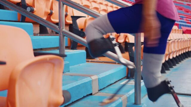 Asian para-athletes disabled with prosthetic blades running at stadium.