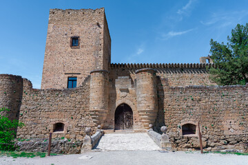 Castillo medieval típico europeo, ni siquiera le falta el nido de cigüeñas, un día soleado con cielo azul, desde Pedraza, Segovia, Castilla y León, España.