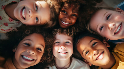 Friendship concept. Group potrait of a cheerful joyful cute little children playing together looking down camera and smiling.
