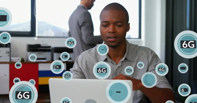 Animation of 5g and 6g text with symbols over thoughtful african american man working on laptop