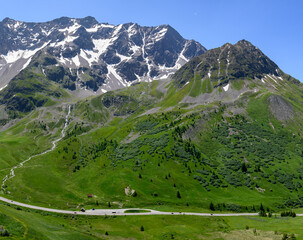 Mountains and alpine meadows views near Col du Lautaret, Massif des Ecrins, Hautes Alpes, France in...