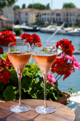 Summer party, drinking of French brut rose champagne sparkling wine in glasses in yacht harbour of Port Grimaud near Saint-Tropez, French Riviera vacation, France