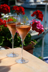 Summer party, drinking of French brut rose champagne sparkling wine in glasses in yacht harbour of Port Grimaud near Saint-Tropez, French Riviera vacation, France