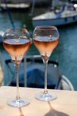 Summer party, drinking of French brut rose champagne sparkling wine in glasses in yacht harbour of Port Grimaud near Saint-Tropez, French Riviera vacation, France