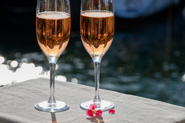 Summer party, drinking of French brut rose champagne sparkling wine in glasses in yacht harbour of Port Grimaud near Saint-Tropez, French Riviera vacation, France