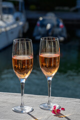 Summer party, drinking of French brut rose champagne sparkling wine in glasses in yacht harbour of Port Grimaud near Saint-Tropez, French Riviera vacation, France