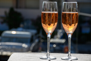 Summer party, drinking of French brut rose champagne sparkling wine in glasses in yacht harbour of Port Grimaud near Saint-Tropez, French Riviera vacation, France