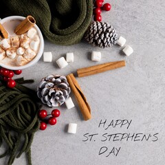 Composite of happy st stephen's day text over hot chocolate mug, scarf, marshmallow, cherry