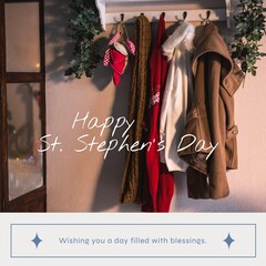 Fototapeta premium Composite of happy st stephen's day text over warm clothing hanging on hook at home