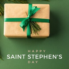 Composite of christmas gift box with happy saint stephen's day text, copy space