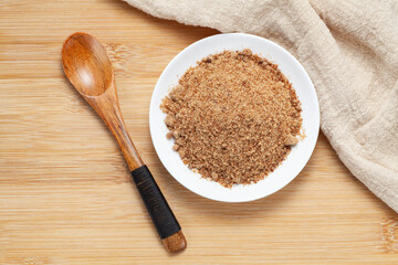 Brown sugar powder in a ceramic dish, Top view.