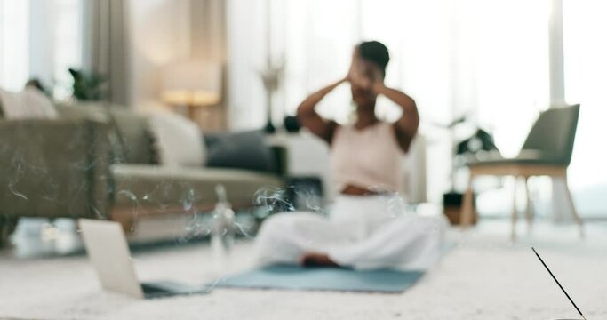 Incense, yoga and meditation with a black woman on the floor of a living room in her home for health or wellness. Exercise, smoke and zen blur with a young person in her apartment for mental health