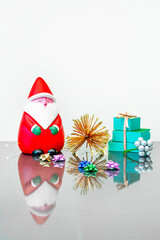 Fototapeta na wymiar Christmas postcard with a Santa Claus and some small gift boxes