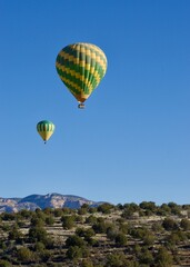 Naklejka premium two hot air balloons in the sky one the Arizona desert