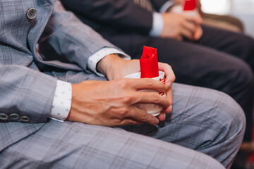 close up of a person holding a cup of coffee