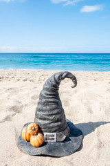 Halloween beach background with witch hat and pumpkins - 664187097