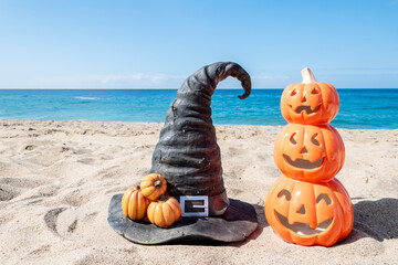 Halloween beach background with pumpkins and witch hat - 664187200
