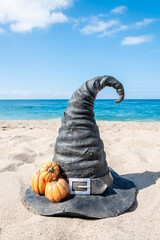 Halloween beach background with witch hat and pumpkins - 664187265