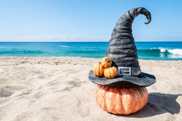Halloween beach background with witch hat pumpkins - 664187448