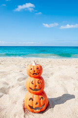 Halloween beach background with three pumpkins - 664187608
