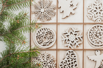 Christmas background, postcard. Christmas wooden decorations in a box and fir branches, holiday in eco style.Christmas eco-friendly decorations.