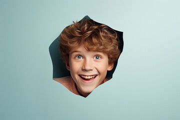 A boy smiles against a pastel background with holes in advertising style