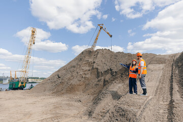 Team of engineers working on sand quarry and control Industrial excavator. Concept open pit mine industry banner