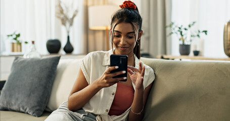 Woman, typing and scroll on cellphone, social media post and update subscription app on sofa at home. Happy indian girl, smartphone and download mobile games, reading notification and chat to contact