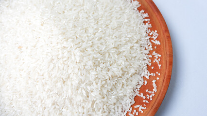 photo of white rice on wooden tray, isolated on white background.