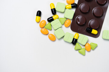 Assortment of pharmaceutical medicine, including pills, tablets, and capsules on white background. Range of pharmaceutical drugs.