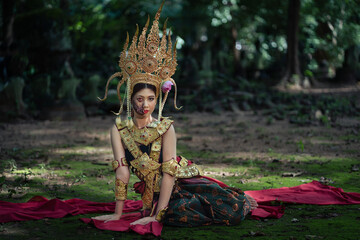 Pretty Asian woman wearing an ancient Traditional Khmer Cambodian Apsara dress costume shows the...