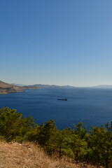 Fototapeta na wymiar fright cargo ship on horizon from geek island kalymnos