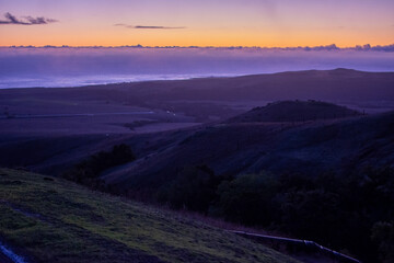 sunset in the mountains along winding road in California 